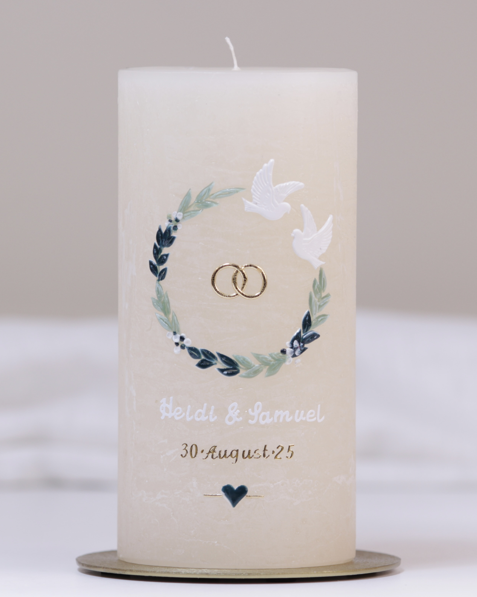 Cremefarbene Hochzeitskerze mit Tauben, Eheringen und Blumenranke – handgegossen mit liebevoller Verzierung.