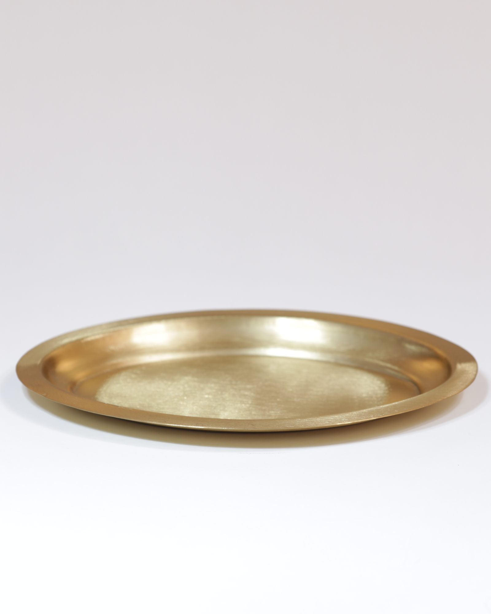 Kerzenteller aus Messing, oval und glatt, mattgoldfarben.